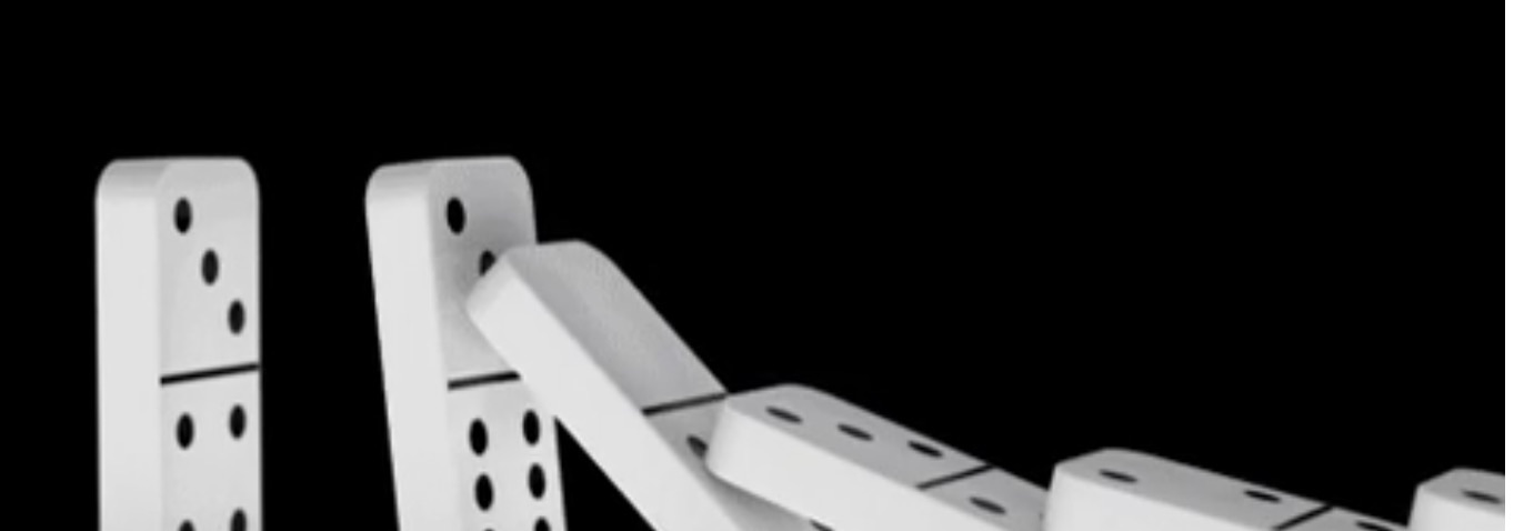 A line of dominoes toppling one into the next against a black background.